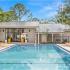 The Loop at Wedgewood clubhouse exterior: clean pool, patio seating, and well-maintained landscaping