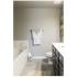 Garden style white tubs. Light grey paint with a towel rack next to the tub. Light grey hard wood flooring