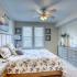 Large bedroom with lots of outside lighting.