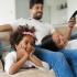 Family watches movie while sitting on the couch