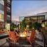 Exterior courtyard with residents sitting by the lit firepit