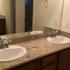 Primary bathroom with granite counters and double sink