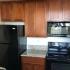 Kitchen view with cherry cabinets and black appliances