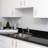 Kitchen with White Cabinets and Black Granite Counter
