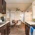 Kitchen with goose neck faucet and dark cabinetry.