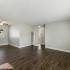grey walls, vinyl plant flooring, windows and ceiling fan with wall a/c unit