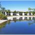 Photo of the lake and a two story building at Coral Woods
