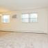 Newport Village model living room with in-unit air conditioning and two windows.