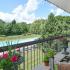 Beautiful balcony view of landscaped grounds and swimming pool from Main Line Berwyn Apartments
