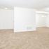 Spacious open layout of living and dining areas with beige carpet in apartment for rent in Newark, DE