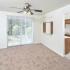 Dining area looking into the kitchen has a ceiling fan and sliding glass patio doors at Victoria Crossing Apartments in Reading, PA.