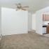 Dining area with a large window and ceiling fan looking into the kitchen at Woodland Plaza Apartments in Wyomissing, PA.