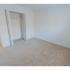 Carpeted bedroom with closet at Mayflower Crossing Apartments in Wilkes-Barre, PA.