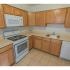 Kitchen with tiled flooring and modern appliances at Mayflower Crossing Apartments in Wilkes-Barre, PA.