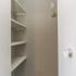spacious walk in closet with shelving and hardwood floors at Eastview Apartments in Springfield MO