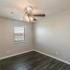 bedroom with hardwood floors and ceiling fan at Eastview Apartments in Springfield MO