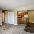 carpeted living room with view into kitchen