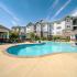 Summit at Nashville West - Sparkling Pool, Sun Lounge Chairs, Seating Area with Umbrellas, and Building Exterior