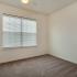 Corner view of bedroom with carpeting and ceiling fan with light fixture