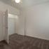Bedroom with carpeting and open doors to double closet