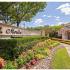 Property Entrance with Luscious Landscaping | St. Moritz Apartments in Dallas, TX