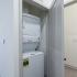 The Crockett - In-Home Washer and Dryer Next to Bathroom with Hardwood Style Flooring.