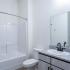 The Crockett - Interior Bathroom with Granite Countertops, Large Vanity, and Shower/Tub Combo.