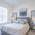 The Crockett - Spacious Bedroom with Large Window, Plush Carpeting, and Expansive Closet.