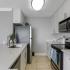 Kitchen with white cabinetry and stainless appliance package.