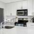 All white kitchen with stainless appliance package