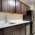 Kitchen with stainless steel appliances at The Argonne Apartments in Columbia Heights