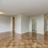 Monticello at Southern Towers living room with hardwood floors and attached kitchen