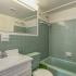 Stratford at Southern Towers bathroom with large mirror and tub/shower
