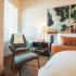 Sora interior bedroom chair next to nightstand next to bed