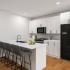 kitchen with bar chairs and appliances in an apartment