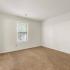 Large carpeted room with window.