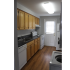 Kitchen with stove, dishwasher, fridge and sink. Washer and dryer in kitchen space.