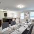 Unit with wall-to-wall carpeting, stairs downstairs, and a kitchen. Staged with a dining and living area.