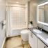Double sink vanity and tub shower combo in recently renovated bathroom.