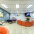 Community area with tables, seating, fireplace and flat screen tv at The Club at Chandler Crossings | MSU Off-Campus Housing .