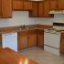 Pine Park Terrace, interior, kitchen, white appliances, dishwasher, stove/oven, tan cabinets, tiled floor, ceiling fan, refrigerator