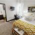 The Venue at North Campus-Interior | Bedroom with small desk and wall mounted TV