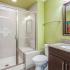 bathroom with one sink, shower, and toilet