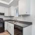 kitchen with black appliances and white cabinets