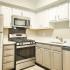 kitchen with stainless steel appliances and grey and white cabinets