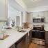 kitchen with grey and white cabinets with stainless steel appliances