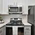 kitchen stove, microwave, and fridge