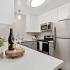 kitchen with stainless steel appliances and grey and white cabinets