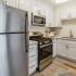 kitchen with stainless steel appliances and white cabinets