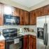 kitchen with black and stainless steel appliances and wood cabinets